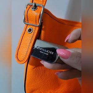 Super bright orange coach purse with long strap
